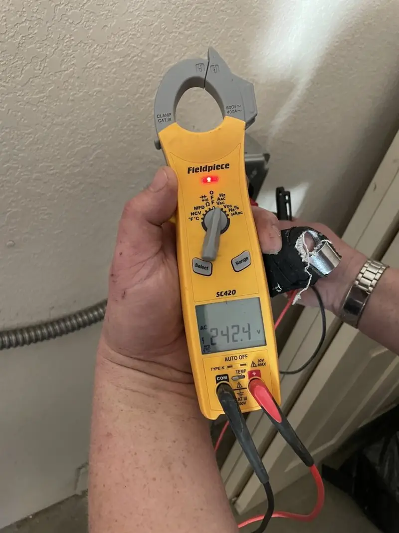 Voltage testing with clamp meter during Electrical Installation Services in Monrovia